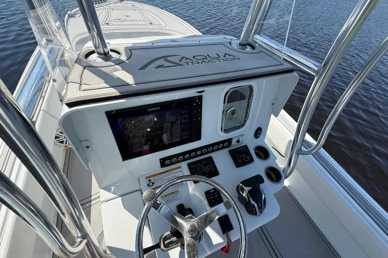  Yacht Photos Pics 2024 Contender 26 Bay boat console with navigation system and steering wheel.