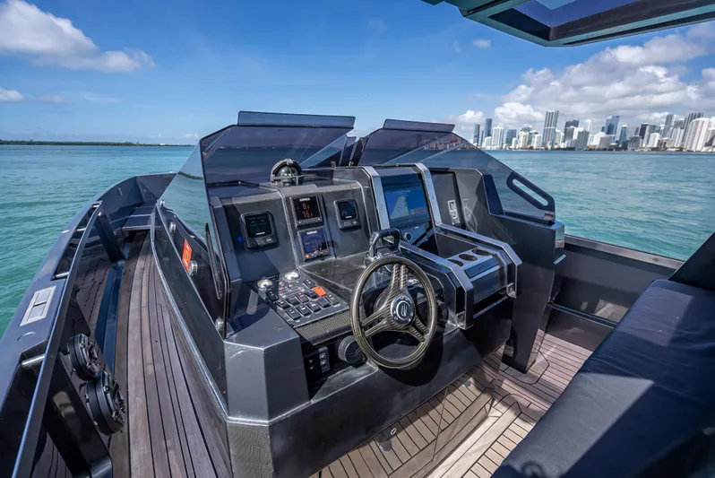  Yacht Photos Pics Luxurious 2012 Wally 43 yacht cockpit with modern controls, overlooking a city skyline.