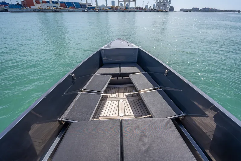  Yacht Photos Pics Bow view of 2012 Wally 43 boat with seating, docked in a harbor.