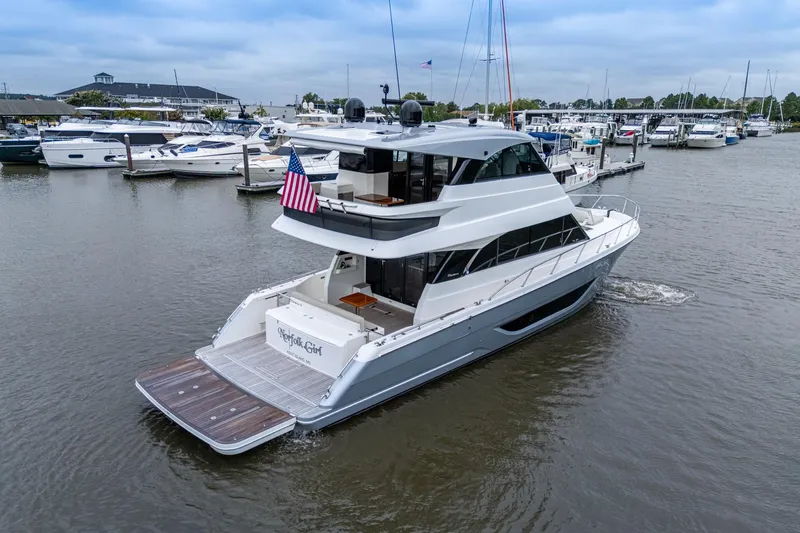 Norfolk Girl Yacht Photos Pics 2023 Maritimo M55 yacht docked in a marina, featuring sleek design and American flag.