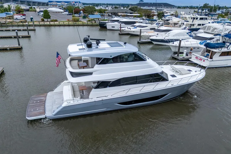 Norfolk Girl Yacht Photos Pics 2023 Maritimo M55 yacht docked in a marina, showcasing sleek design and luxury features.