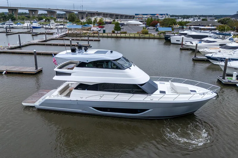 Norfolk Girl Yacht Photos Pics 2023 Maritimo M55 yacht docked in a marina, showcasing sleek design and modern features.