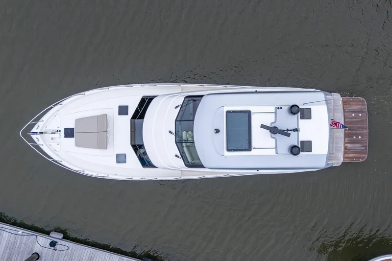 Norfolk Girl Yacht Photos Pics Aerial view of 2023 Maritimo M55 yacht on water, showcasing sleek design and spacious deck.