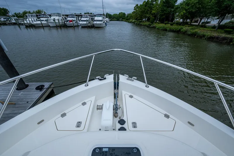 Norfolk Girl Yacht Photos Pics Bow view of 2023 Maritimo M55 yacht docked in a marina.
