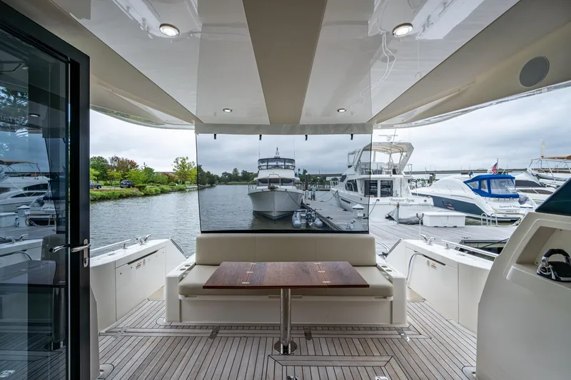 Norfolk Girl Yacht Photos Pics 2023 Maritimo M55 yacht interior with docked boats in marina view.
