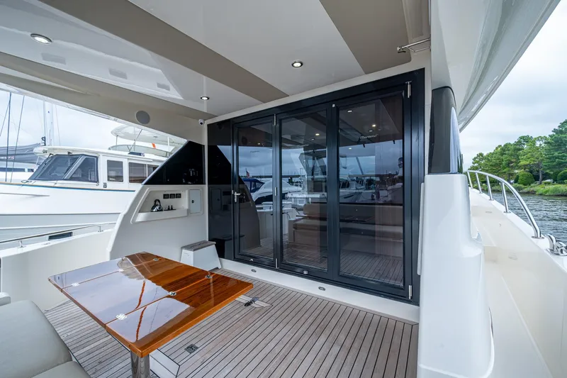 Norfolk Girl Yacht Photos Pics 2023 Maritimo M55 yacht deck with sleek design and modern glass doors.