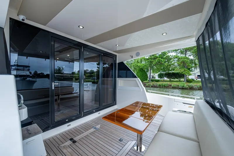 Norfolk Girl Yacht Photos Pics Luxurious 2023 Maritimo M55 yacht interior with sleek design and spacious seating area.