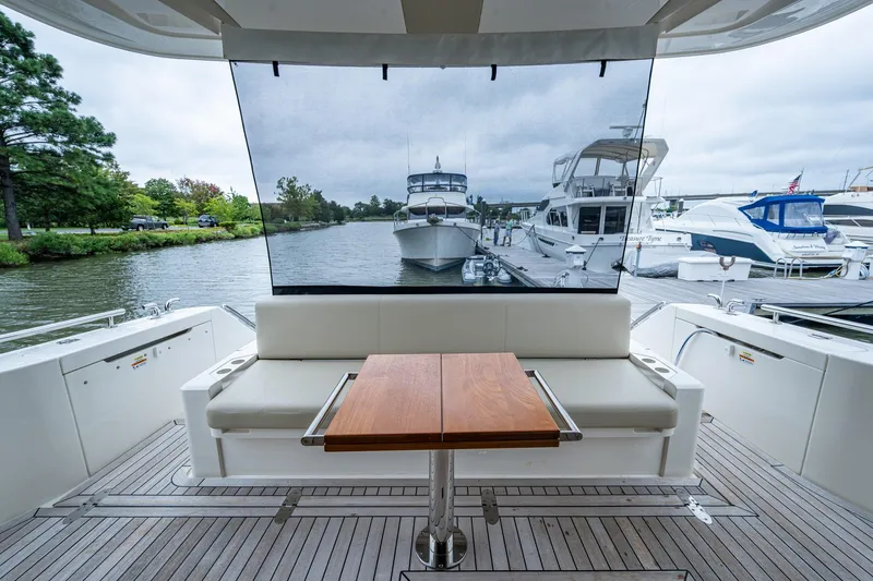 Norfolk Girl Yacht Photos Pics 2023 Maritimo M55 yacht interior with seating and table, docked at marina.