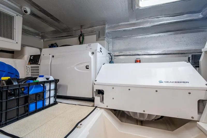 Norfolk Girl Yacht Photos Pics Engine room of 2023 Maritimo M55 yacht with Seakeeper stabilizer and storage containers.