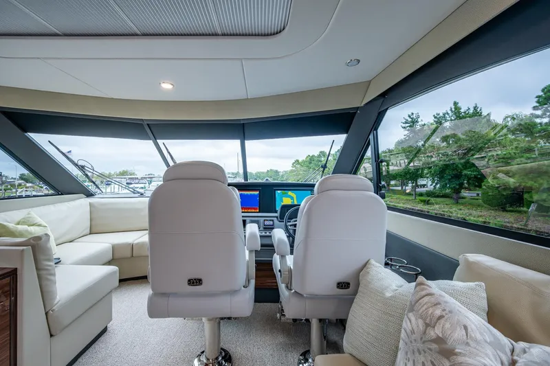 Norfolk Girl Yacht Photos Pics Luxurious interior of 2023 Maritimo M55 yacht with helm and panoramic windows.