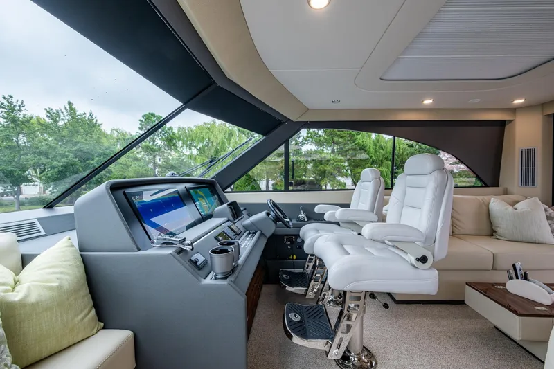 Norfolk Girl Yacht Photos Pics Luxurious 2023 Maritimo M55 yacht interior with modern helm and plush seating.