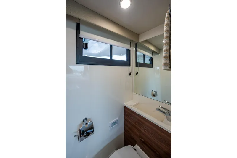 Norfolk Girl Yacht Photos Pics Luxurious bathroom interior of 2023 Maritimo M55 yacht with modern fixtures and window.