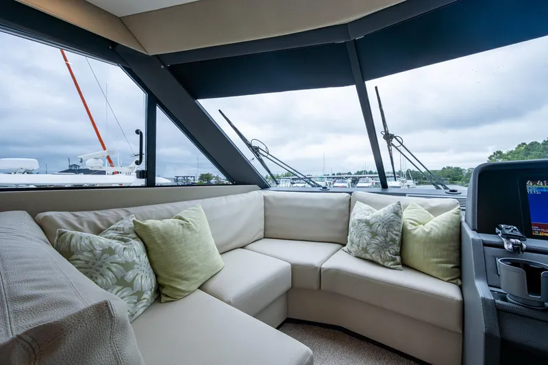 Norfolk Girl Yacht Photos Pics Luxurious interior of 2023 Maritimo M55 yacht with plush seating and scenic window views.