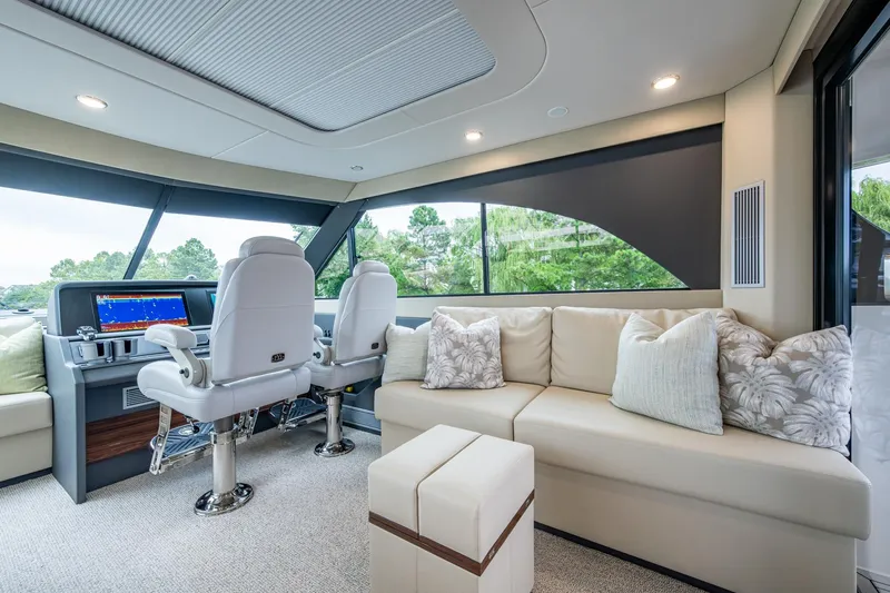 Norfolk Girl Yacht Photos Pics Luxurious interior of 2023 Maritimo M55 yacht with plush seating and modern helm.