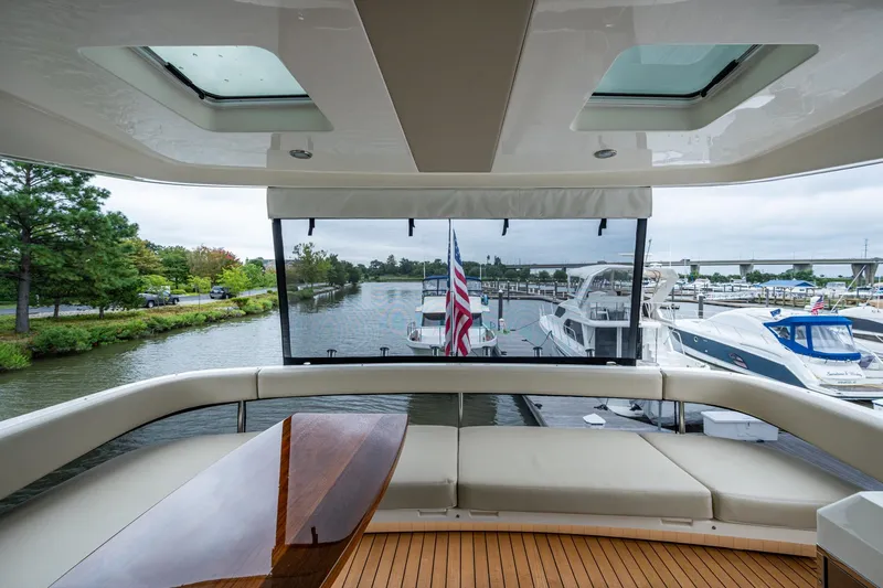Norfolk Girl Yacht Photos Pics Luxurious 2023 Maritimo M55 yacht interior with scenic marina view.