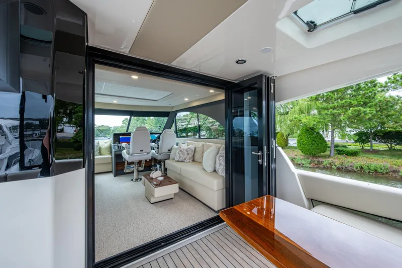 Norfolk Girl Yacht Photos Pics Luxurious interior of 2023 Maritimo M55 yacht with elegant seating and scenic views.
