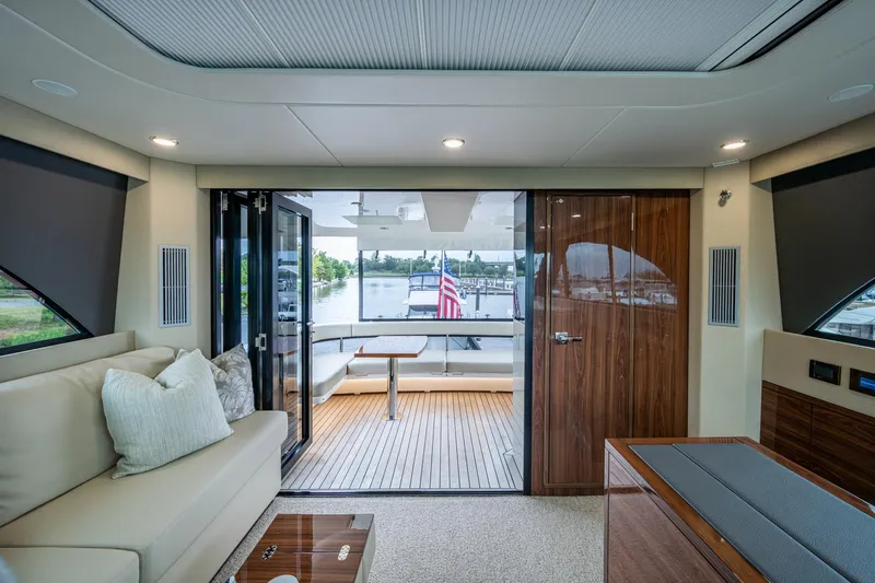 Norfolk Girl Yacht Photos Pics Luxurious interior of 2023 Maritimo M55 yacht with elegant seating and outdoor view.