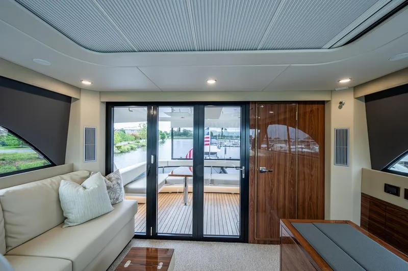 Norfolk Girl Yacht Photos Pics Luxurious interior of 2023 Maritimo M55 yacht with elegant seating and scenic view.