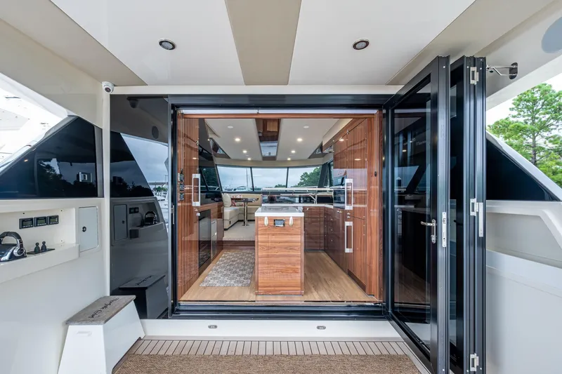 Norfolk Girl Yacht Photos Pics Luxurious interior of 2023 Maritimo M55 yacht with modern kitchen and open design.