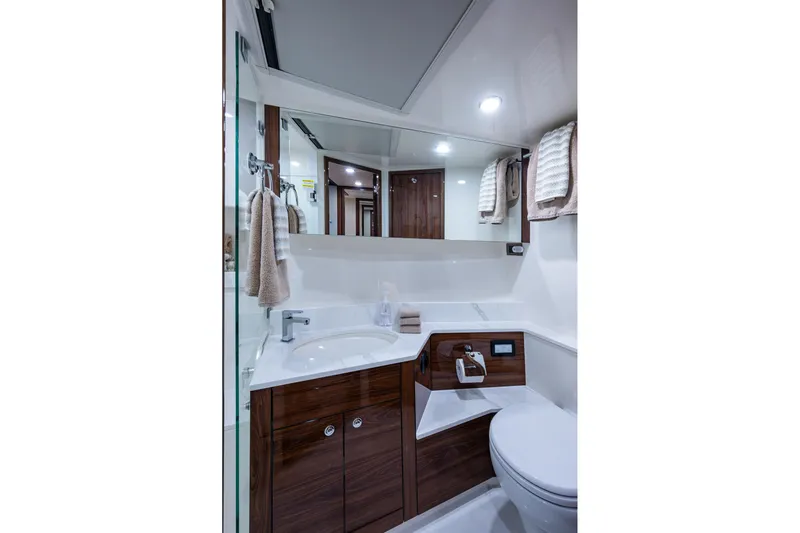 Norfolk Girl Yacht Photos Pics Luxurious bathroom in 2023 Maritimo M55 yacht with modern fixtures and elegant wood accents.