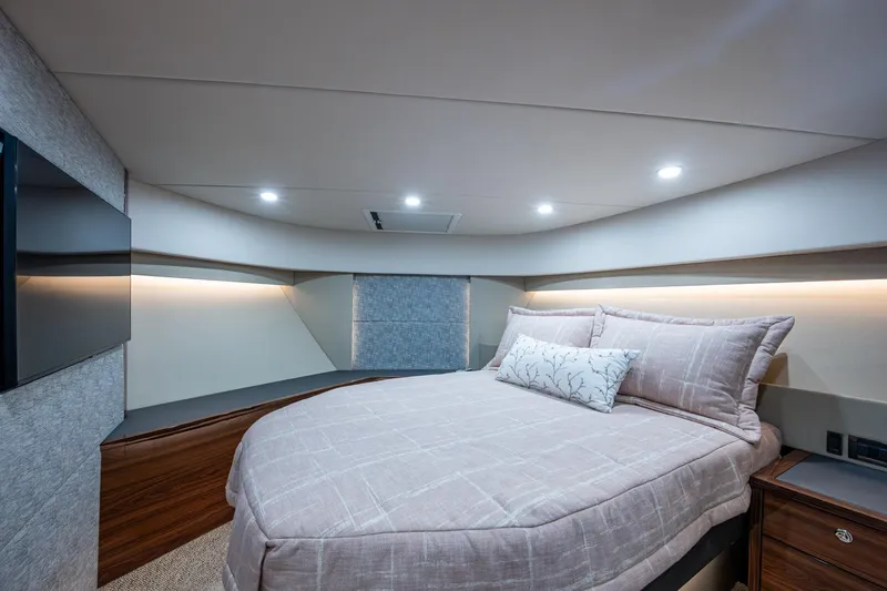 Norfolk Girl Yacht Photos Pics Luxurious bedroom interior of 2023 Maritimo M55 yacht with modern design and ambient lighting.