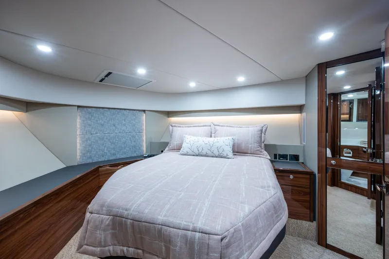 Norfolk Girl Yacht Photos Pics Luxurious bedroom interior of 2023 Maritimo M55 yacht with elegant bedding and modern lighting.