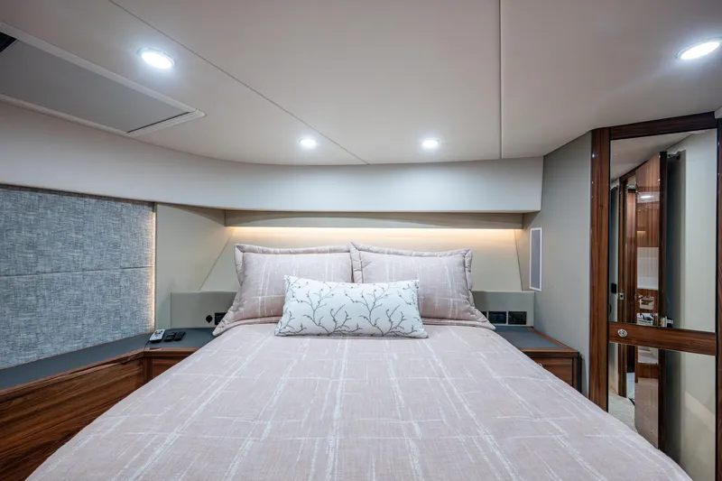Norfolk Girl Yacht Photos Pics Luxurious bedroom interior of 2023 Maritimo M55 yacht with elegant bedding and modern lighting.