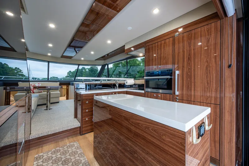 Norfolk Girl Yacht Photos Pics Luxurious interior of 2023 Maritimo M55 yacht with modern kitchen and panoramic windows.
