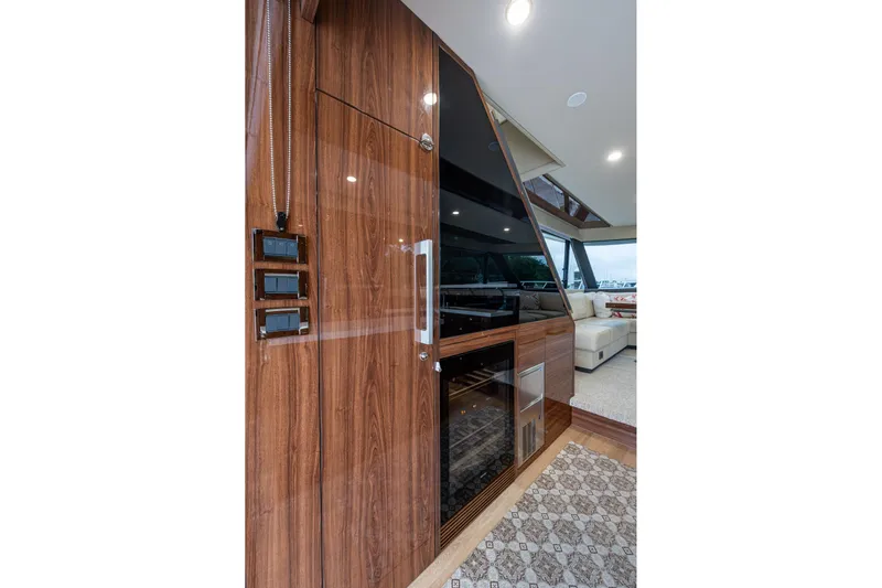 Norfolk Girl Yacht Photos Pics Luxurious interior of 2023 Maritimo M55 yacht with elegant wood paneling and modern design.