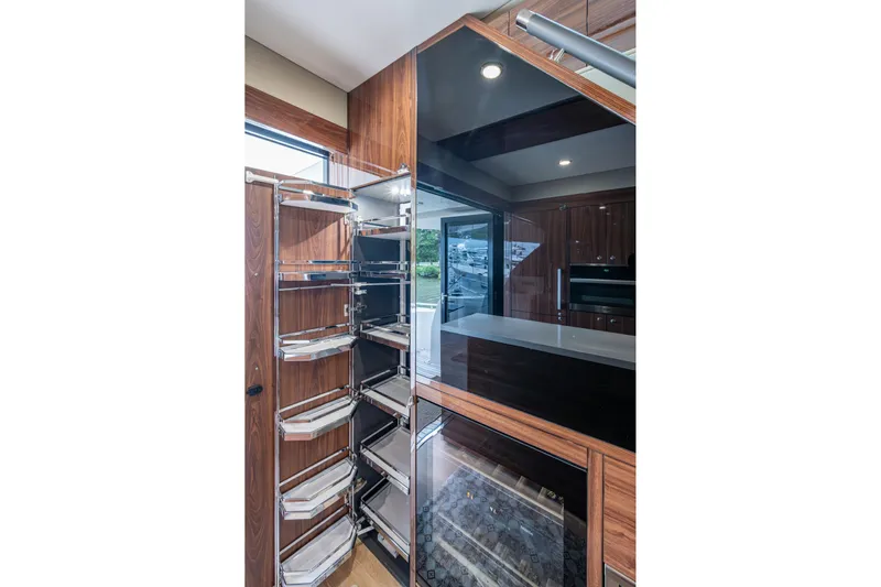 Norfolk Girl Yacht Photos Pics Luxurious interior of 2023 Maritimo M55 yacht featuring modern kitchen cabinetry and storage.