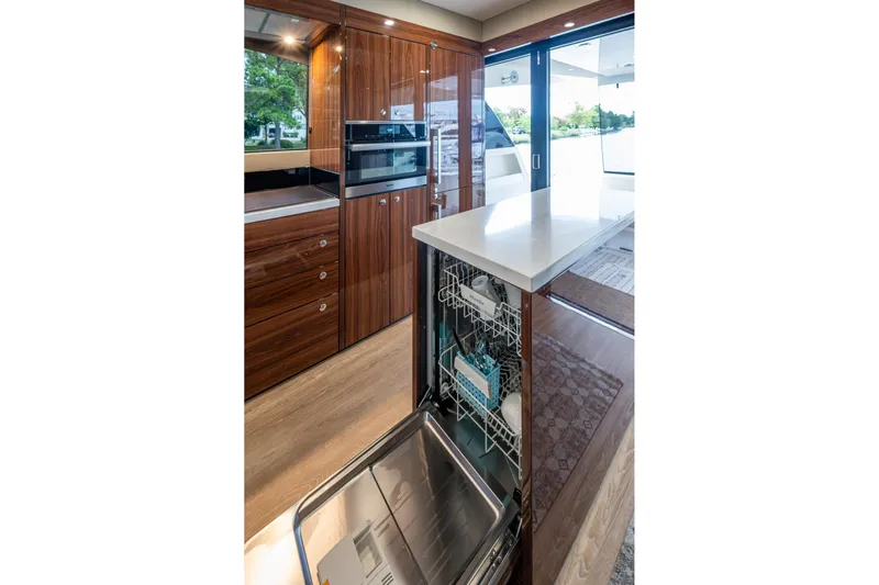 Norfolk Girl Yacht Photos Pics Luxurious 2023 Maritimo M55 yacht kitchen with modern appliances and elegant wood cabinetry.