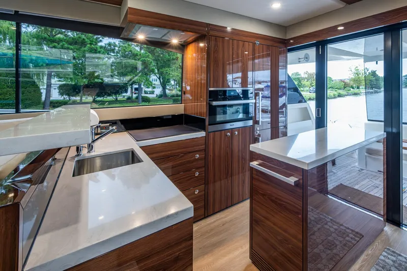 Norfolk Girl Yacht Photos Pics Luxurious 2023 Maritimo M55 yacht kitchen with modern appliances and elegant wood finishes.