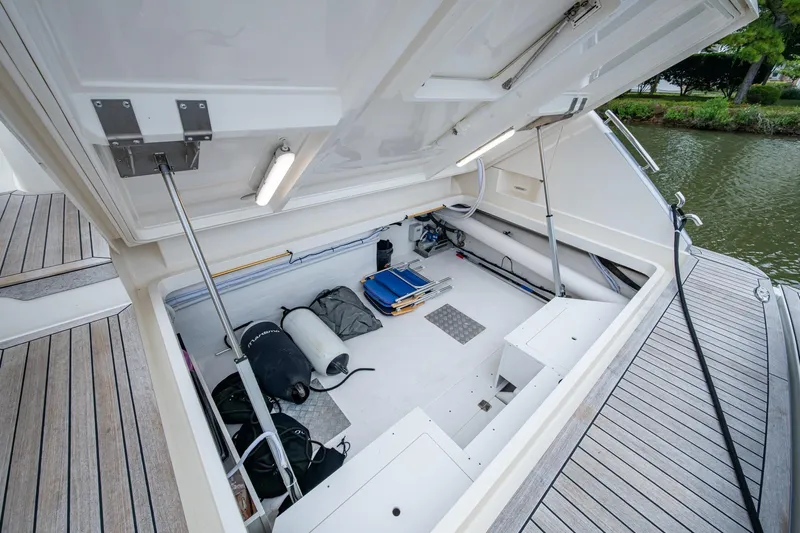 Norfolk Girl Yacht Photos Pics Open storage compartment on 2023 Maritimo M55 yacht, featuring various equipment and gear.