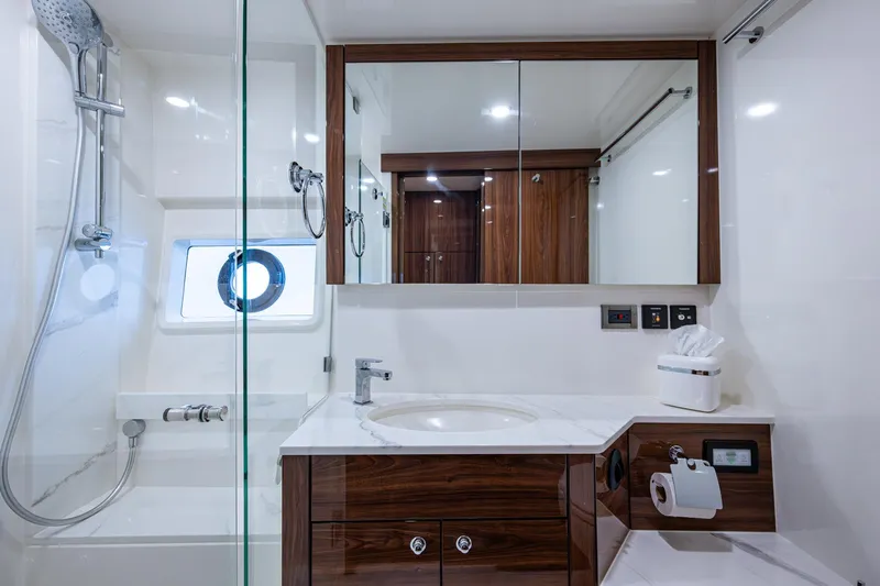 Norfolk Girl Yacht Photos Pics Luxurious bathroom in 2023 Maritimo M55 yacht with modern fixtures and elegant wood accents.