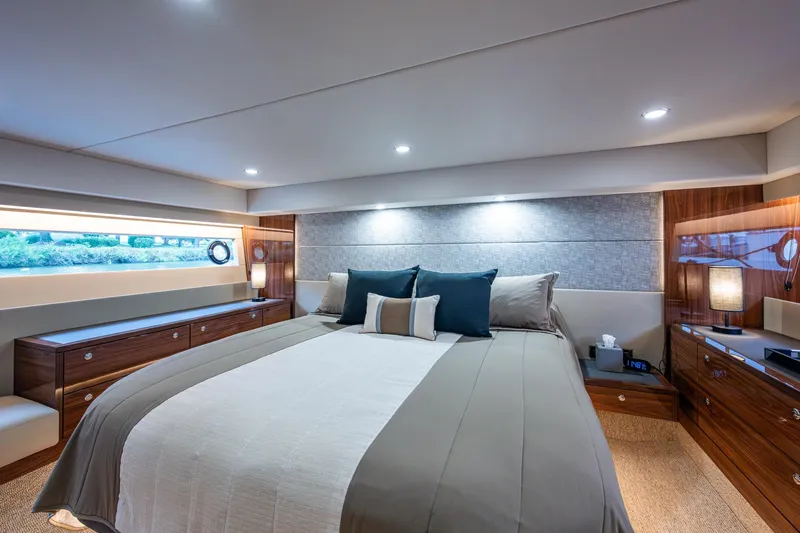 Norfolk Girl Yacht Photos Pics Luxurious bedroom interior of 2023 Maritimo M55 yacht with elegant wood finishes.