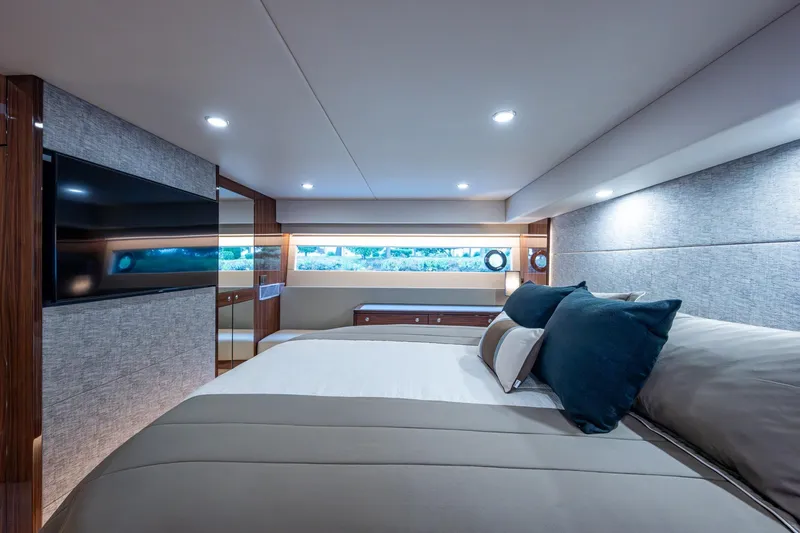 Norfolk Girl Yacht Photos Pics Luxurious interior of 2023 Maritimo M55 yacht bedroom with modern design and ambient lighting.