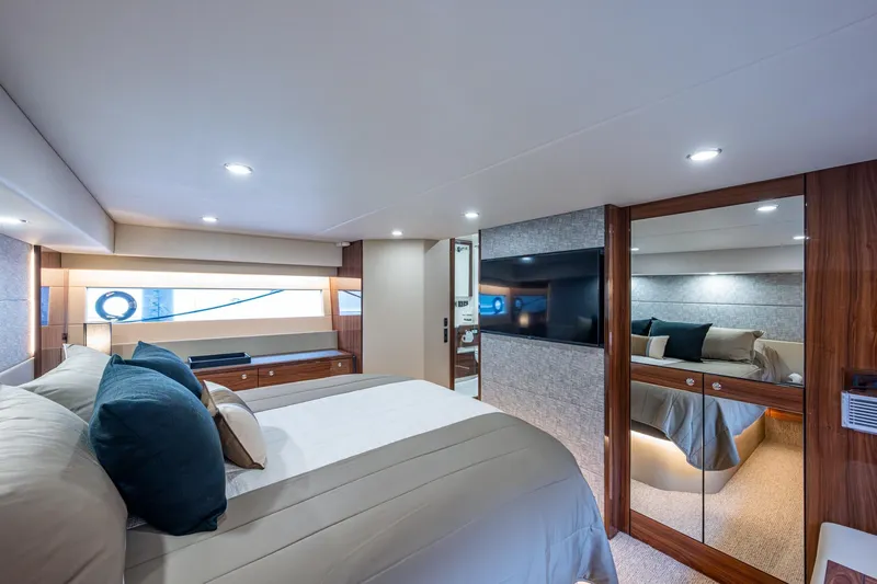 Norfolk Girl Yacht Photos Pics Luxurious bedroom interior of 2023 Maritimo M55 yacht with modern design and elegant furnishings.