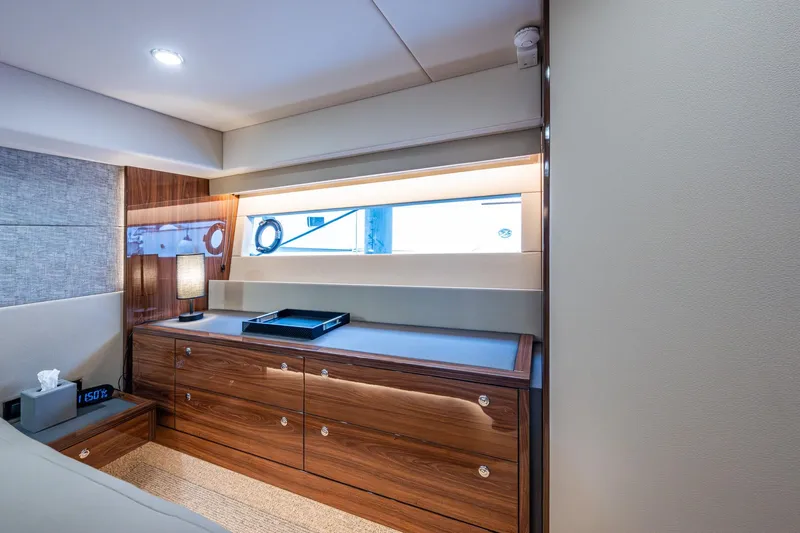 Norfolk Girl Yacht Photos Pics Luxurious interior of 2023 Maritimo M55 yacht with elegant wood cabinetry and modern lighting.