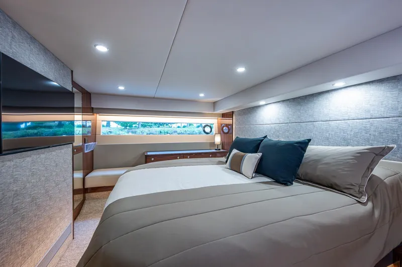 Norfolk Girl Yacht Photos Pics Luxurious bedroom interior of 2023 Maritimo M55 yacht with modern design and ambient lighting.
