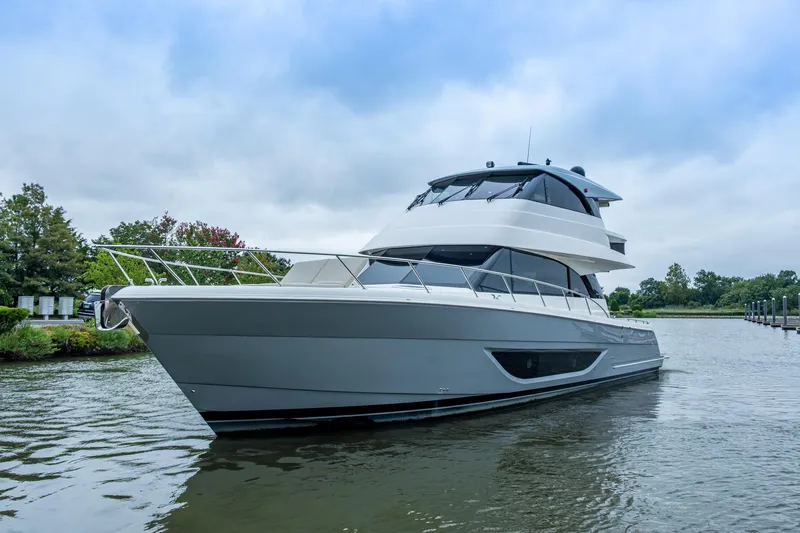 Norfolk Girl Yacht Photos Pics 2023 Maritimo M55 yacht on calm water, showcasing sleek design and modern features.