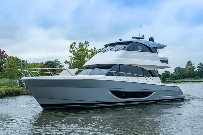 Norfolk Girl Yacht Photos Pics 2023 Maritimo M55 luxury yacht cruising on a serene waterway.