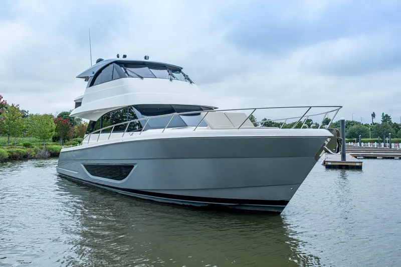 Norfolk Girl Yacht Photos Pics 2023 Maritimo M55 yacht docked on calm water, showcasing sleek design and modern features.