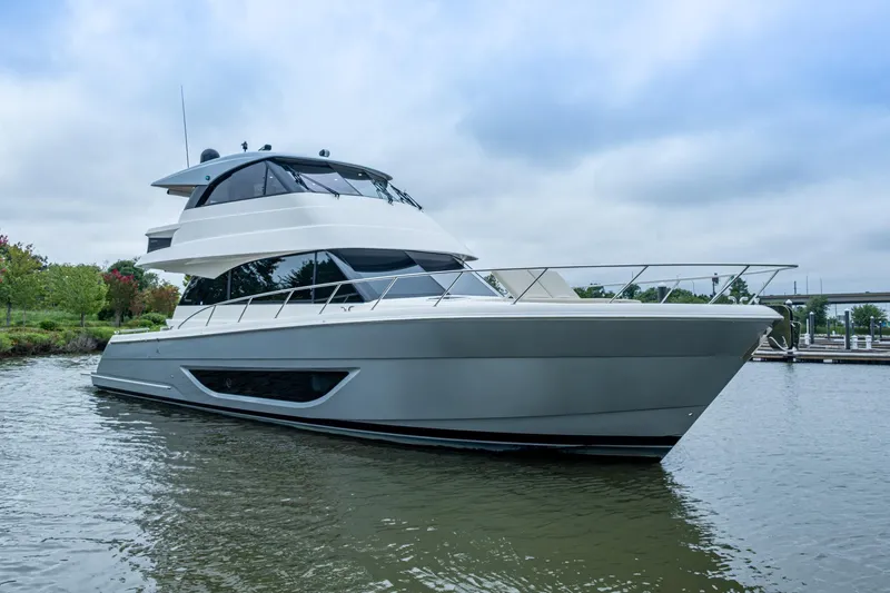 Norfolk Girl Yacht Photos Pics 2023 Maritimo M55 luxury yacht on calm water, showcasing sleek design and modern features.