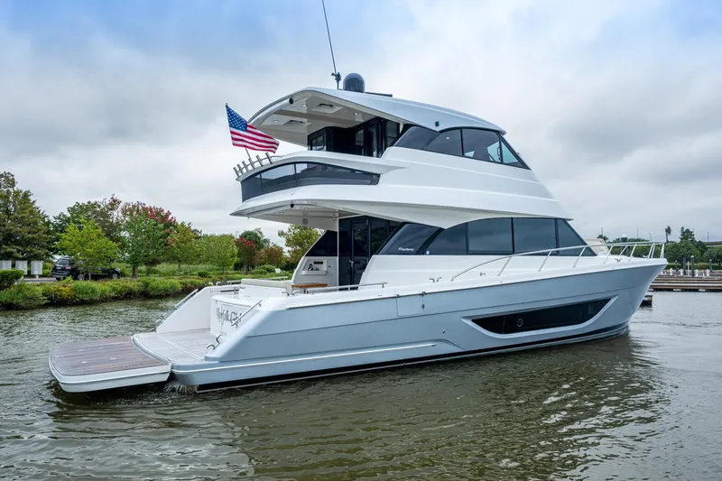 Norfolk Girl Yacht Photos Pics 2023 Maritimo M55 yacht on water, featuring sleek design and American flag.
