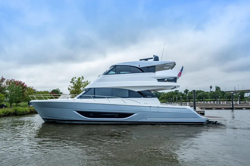 Norfolk Girl Yacht Photos Pics 2023 Maritimo M55 yacht on water, sleek design, overcast sky, dock in background.