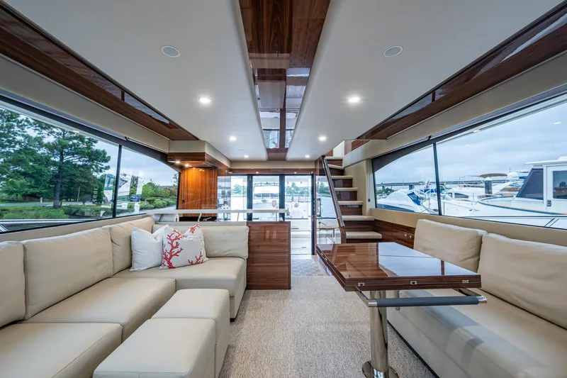 Norfolk Girl Yacht Photos Pics Luxurious interior of 2023 Maritimo M55 yacht with elegant seating and panoramic windows.