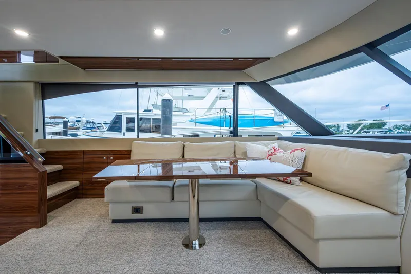 Norfolk Girl Yacht Photos Pics Luxurious interior of 2023 Maritimo M55 yacht with elegant seating and large windows.