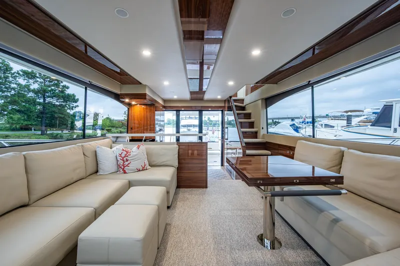 Norfolk Girl Yacht Photos Pics Luxurious interior of 2023 Maritimo M55 yacht with elegant seating and panoramic windows.