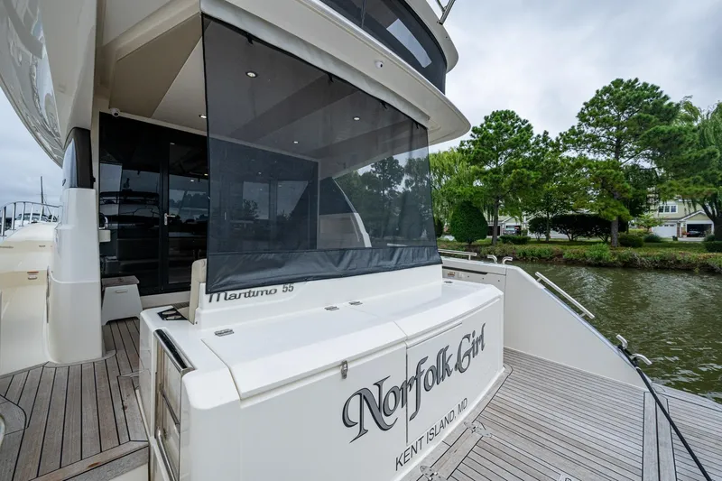 Norfolk Girl Yacht Photos Pics 2023 Maritimo M55 yacht docked, featuring elegant design and spacious deck area.