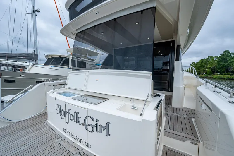 Norfolk Girl Yacht Photos Pics 2023 Maritimo M55 yacht docked, featuring spacious deck and sleek design.